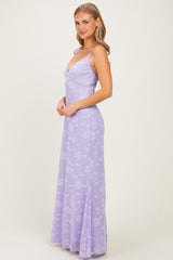 woman wearing a lavender floral maxi dress with spaghetti straps and a fitted bodice