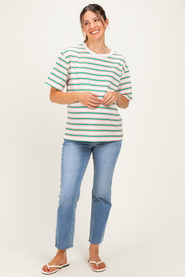 woman wearing a striped maternity top with short sleeves and a relaxed fit, paired with blue jeans
