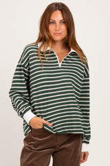 woman wearing a dark green and white striped long sleeve quarter zip top with a relaxed fit and white collar