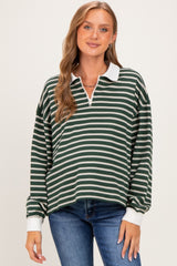 woman wearing a green and white striped long sleeve maternity top with a collar and a relaxed fit