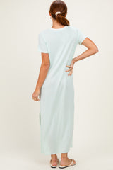 woman wearing a light mint green short sleeve maxi dress, viewed from the back