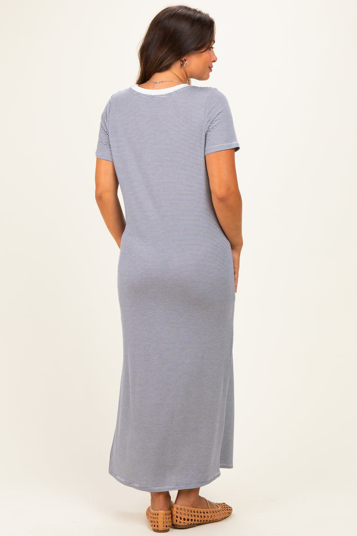 woman wearing a gray striped maternity maxi dress with short sleeves and a relaxed fit, showing a baby bump