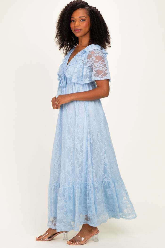 woman wearing a light blue lace maxi dress with short sleeves and a ruffled hem, posed sideways against a neutral background