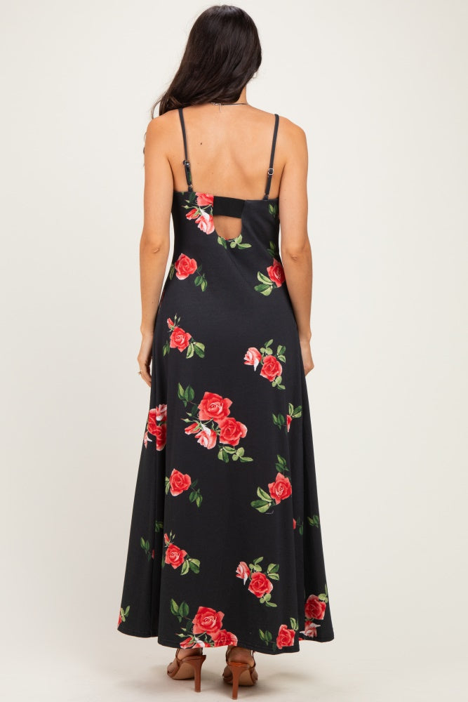 woman wearing a black maxi dress with red floral print and a back cutout, straps visible on shoulders