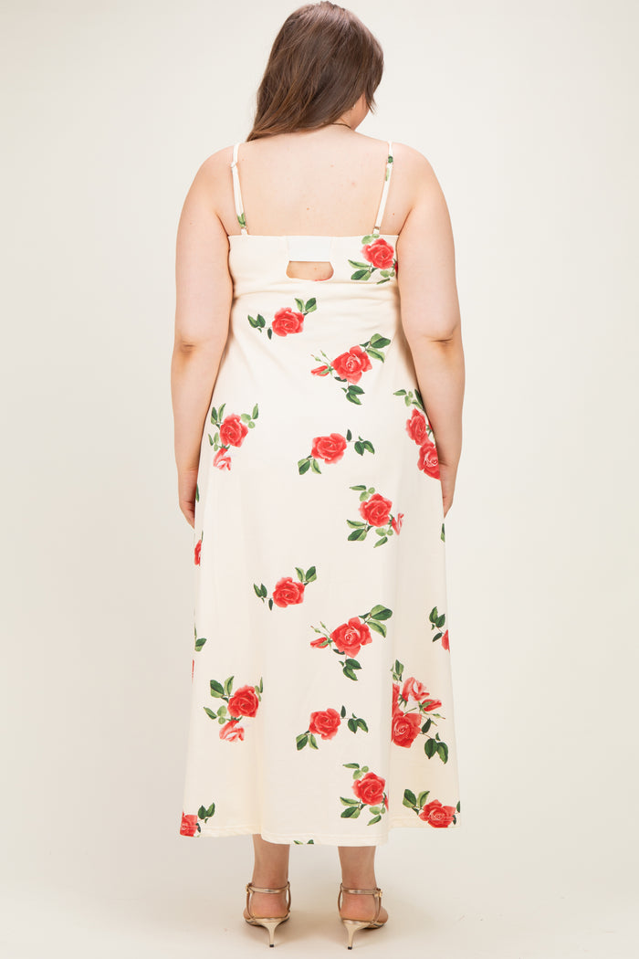 woman wearing a cream maternity plus maxi dress with a floral print and back cutout detail