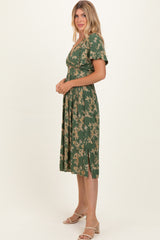 woman wearing a green floral midi dress with a v-neckline and short sleeves