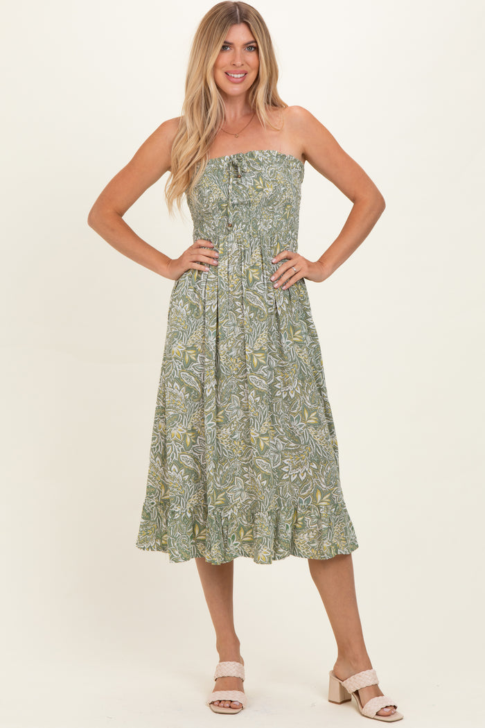 woman wearing a strapless green floral midi dress with a tiered skirt and buttons down the front