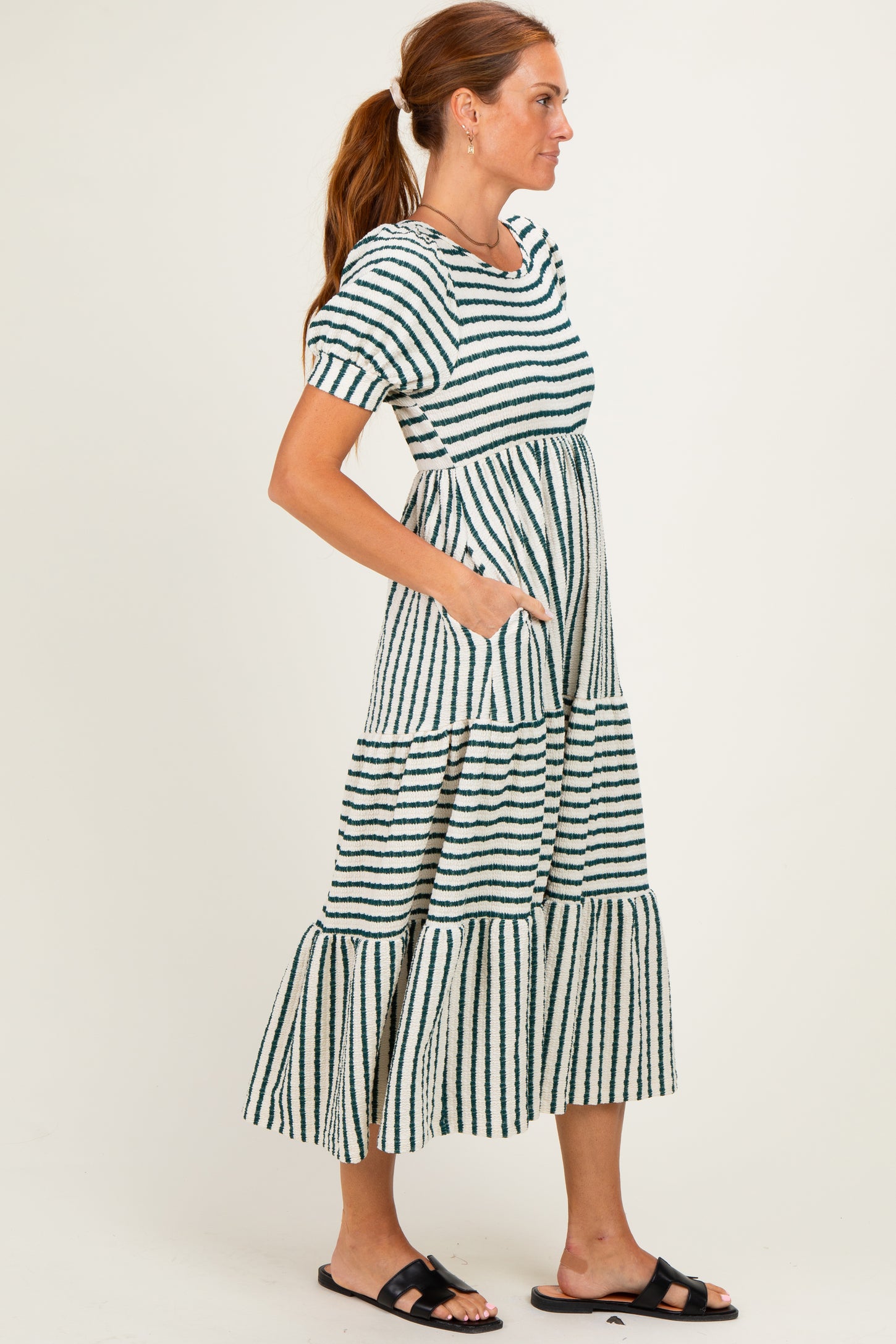 woman wearing a striped short sleeve tiered maxi dress with pockets and a relaxed fit
