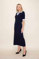 woman wearing a navy blue knitted midi dress with a light blue collar and short white sleeves, paired with black heels
