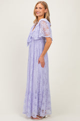 woman wearing a light purple lace maxi dress with short sleeves and a tie detail at the neckline
