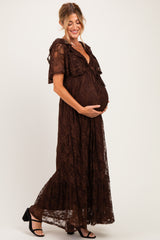 woman wearing a brown lace maternity maxi dress and holding her baby bump