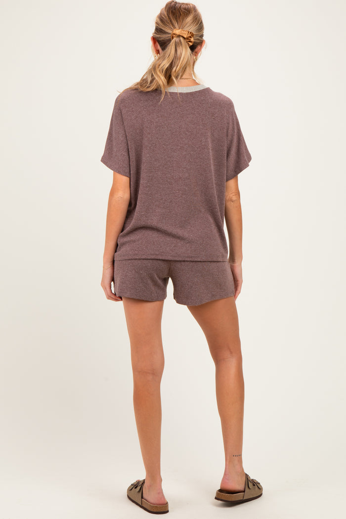 woman wearing a brown short sleeve maternity loungewear set with shorts, showing a comfortable fit from the back