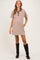 woman wearing a brown and white striped maternity shirt dress with a collar and pockets, displaying a baby bump