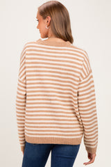 woman wearing a beige and white striped maternity sweater, viewed from the back, with a relaxed fit