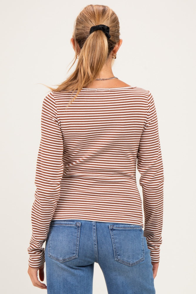 woman wearing a striped maternity long sleeve top with a fitted style, viewed from the back with blue jeans