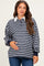 woman wearing a navy and gray striped maternity top with a white collar, holding her baby bump