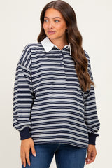 woman wearing a navy and gray striped maternity pullover with a white collar and relaxed fit showing her baby bump
