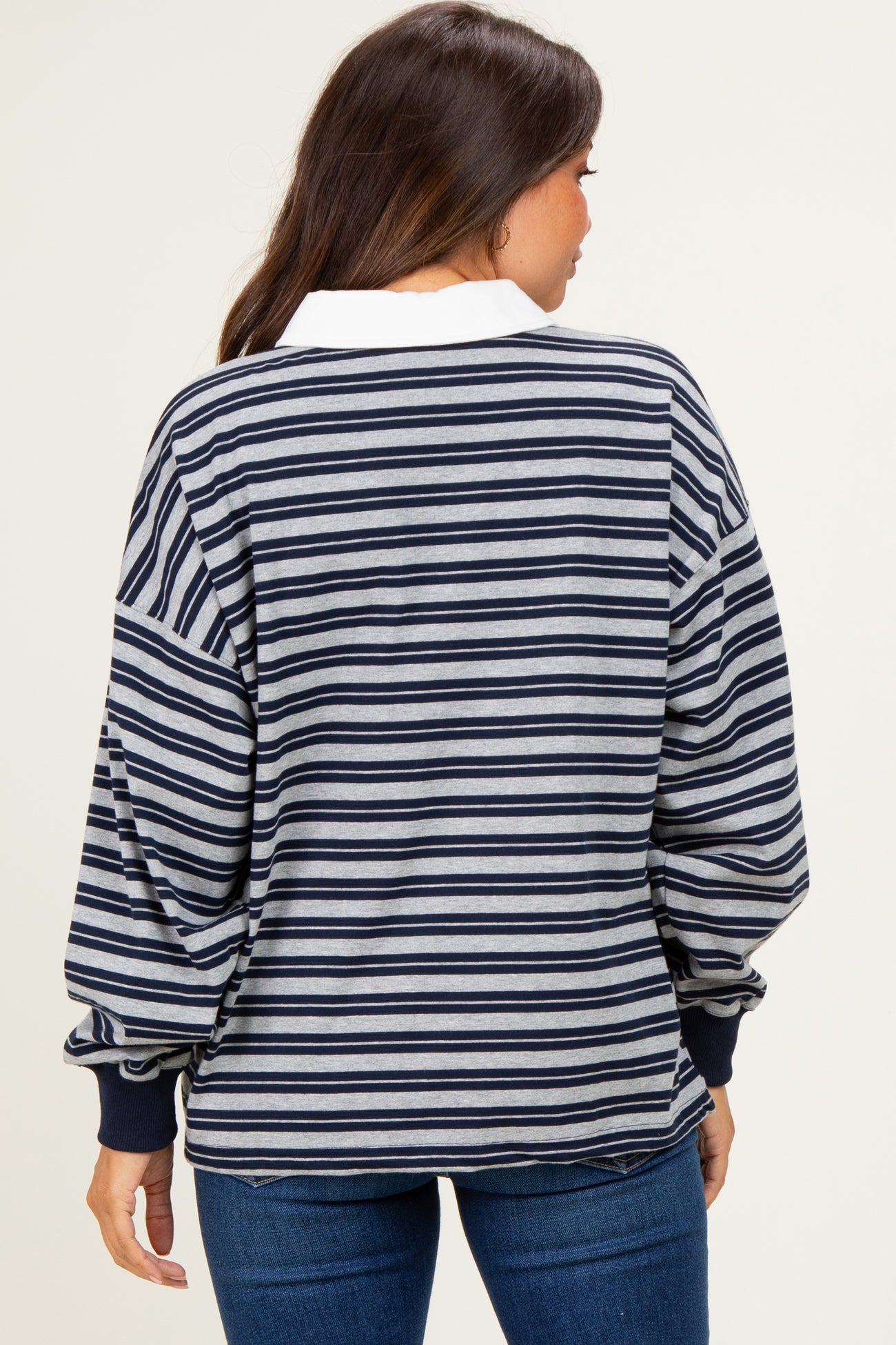 woman wearing a striped maternity sweatshirt with long sleeves and a white collar, viewed from the back