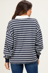 woman wearing a striped maternity sweatshirt with long sleeves and a white collar, viewed from the back