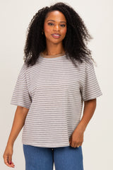 woman wearing a beige and brown striped oversized t-shirt with short sleeves and a relaxed fit