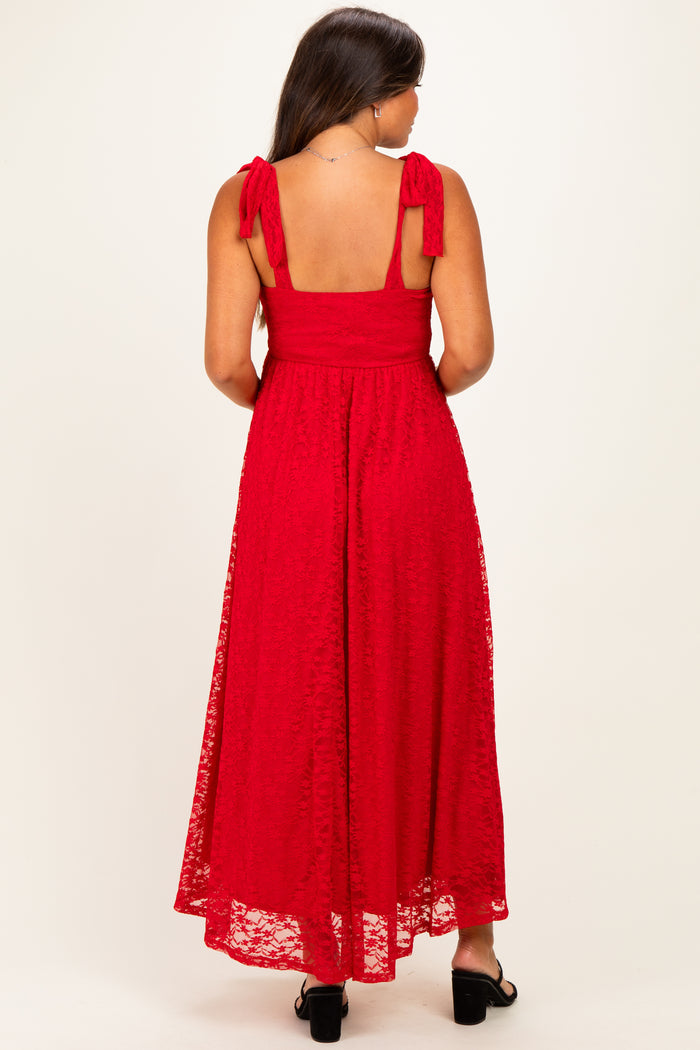 woman wearing a red lace maternity maxi dress with tie shoulder straps, showing a baby bump from the back