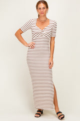 woman wearing a fitted cream and rust striped maxi dress with short sleeves and a knotted front detail