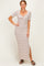 woman wearing a fitted cream and rust striped maxi dress with short sleeves and a knotted front detail