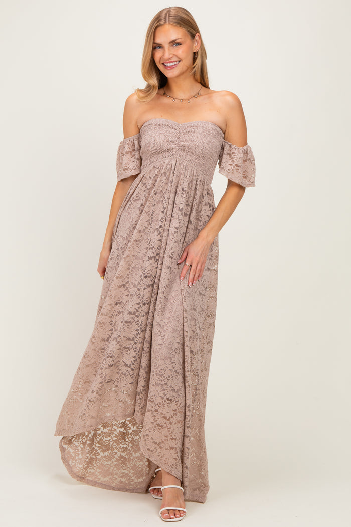 woman wearing a light brown off-the-shoulder lace maxi dress with short sleeves and a high-low hemline