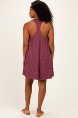 woman wearing a burgundy sleeveless backless dress with a loose fit and vertical stripes