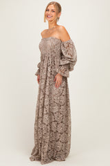 woman wearing a brown floral lace off-shoulder maxi dress with puff sleeves