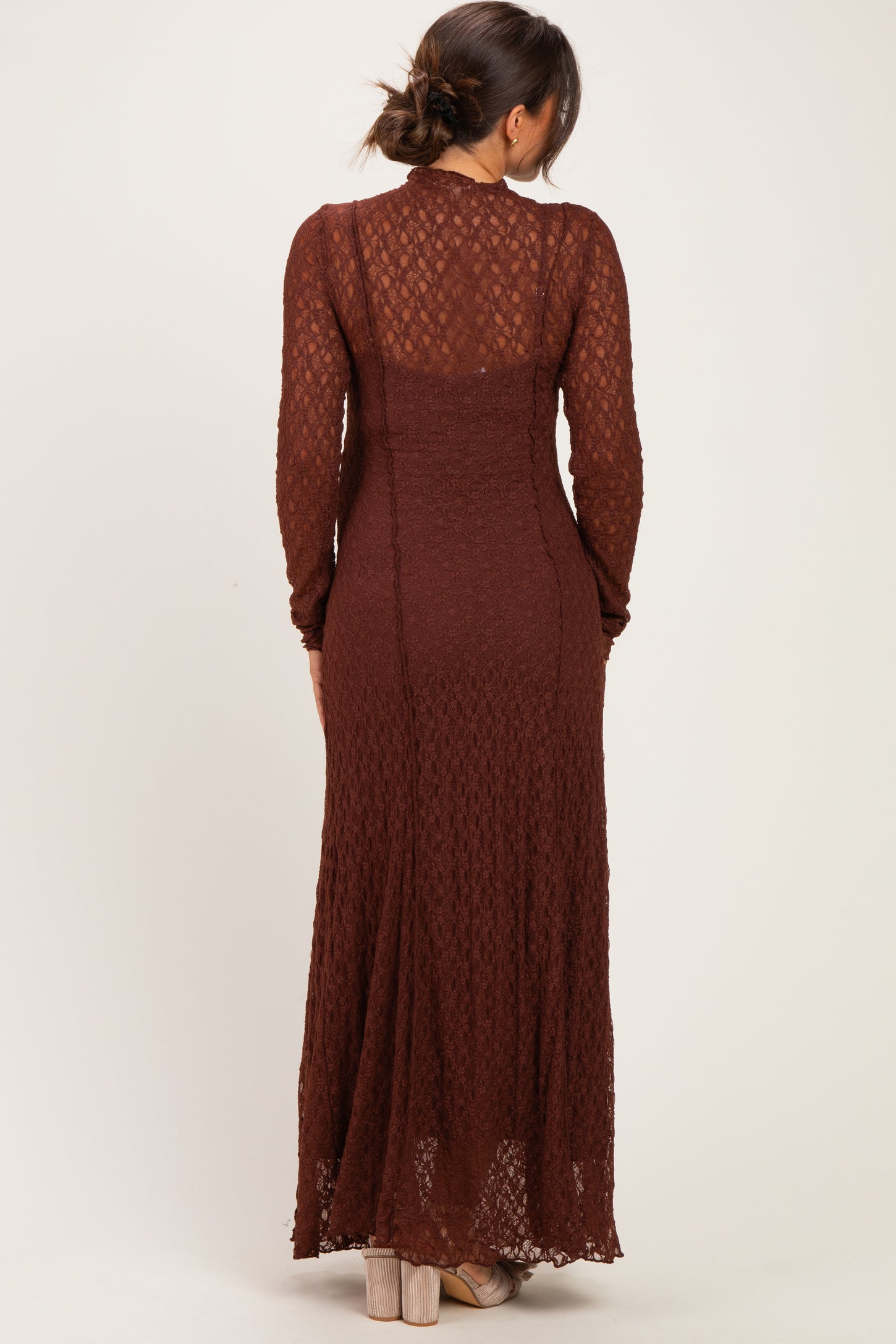 woman wearing a brown long sleeve lace maternity dress seen from the back