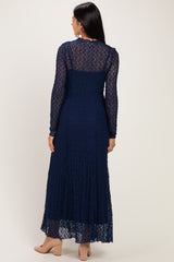 woman wearing a navy blue long sleeve lace maxi dress from the back, featuring a tiered skirt and a fitted bodice