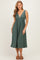 woman wearing a dark green pleated midi dress with a v-neckline and flared skirt