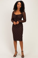 woman wearing a brown lace long sleeve dress with a fitted silhouette and a scoop neckline