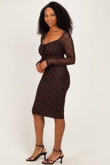 woman wearing a brown lace bodycon dress with long sleeves and a square neckline, standing and smiling