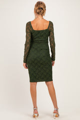 woman wearing a dark green lace long sleeve maternity dress, showcased from the back