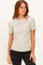 woman wearing a light beige ribbed short sleeve top and black jeans