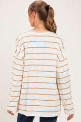 woman wearing a beige and cream striped long sleeve maternity top viewed from the back
