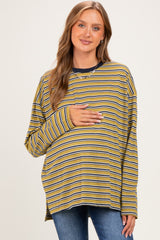 woman wearing a yellow and navy striped maternity top and holding her baby bump