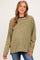 woman wearing a mustard striped maternity top with long sleeves, smiling and showing her baby bump
