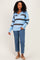 woman wearing a light blue and brown striped sweater with a collar and blue jeans