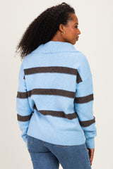 woman wearing a light blue striped sweater with dark brown stripes, shown from the back with curly hair