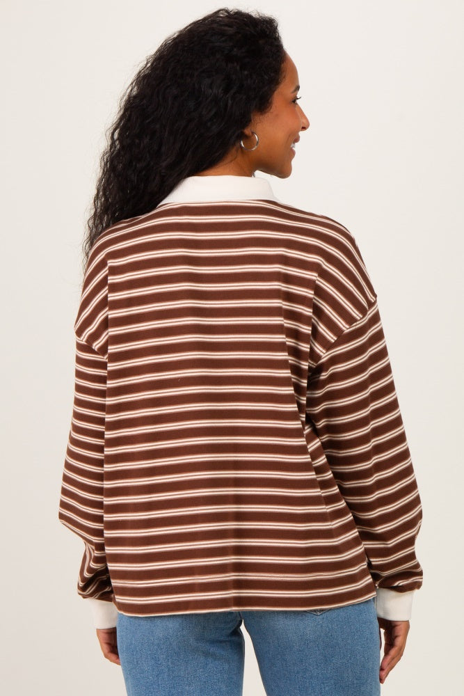 woman wearing a brown and cream striped maternity shirt, shown from the back with loose sleeves and a relaxed fit