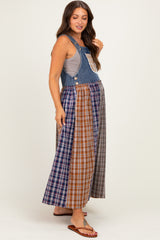 woman wearing a denim maternity maxi dress with a patchwork plaid skirt and a sleeveless top, showing her baby bump