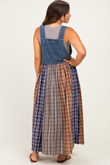 woman wearing a denim maternity maxi dress with a plaid skirt and a gray tank top underneath