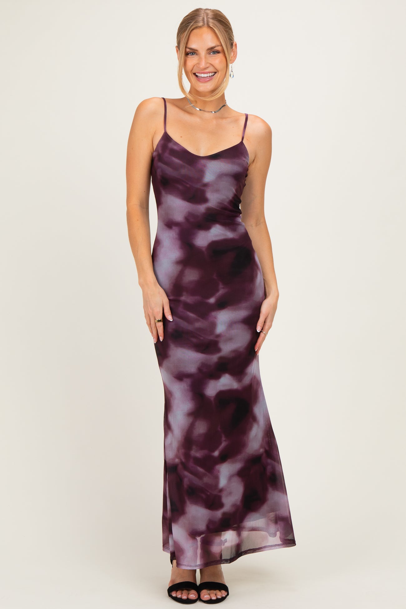 woman wearing a purple and grey tie-dye maxi slip dress with spaghetti straps and a flowing skirt