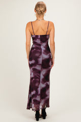 woman wearing a purple and white tie-dye maxi dress with thin straps, showing the back view