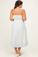 woman wearing a floral print maternity dress with spaghetti straps and a smocked back, revealing baby bump