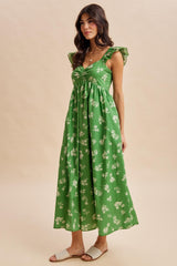 woman wearing a green floral maxi dress with ruffled sleeves and a fitted bodice