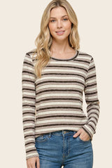 woman wearing a cream and brown striped long sleeve top with a round neckline and casual fit
